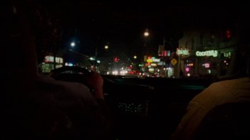 Movie still from “Old Joy” (2006), directed by Kelly Reichardt – A car driving down a street at night with lights on; Close Up shot, Over the shoulder angle