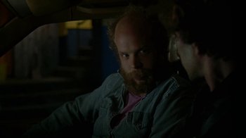 Movie still from “Old Joy” (2006), directed by Kelly Reichardt – A man with a goatee and beard sitting next to a woman; Close Up shot, Over the shoulder angle