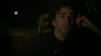 Movie still from “Old Joy” (2006), directed by Kelly Reichardt – A man sitting in a car at night with his eyes closed; Close Up shot, Low angle