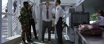 Movie still from “Old School” (2003), directed by Todd Phillips – A man standing next to another man with his hands behind his head; Wide shot, Low angle