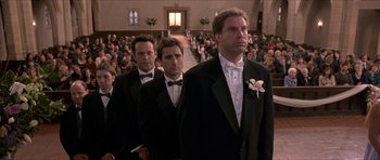 Movie still from “Old School” (2003), directed by Todd Phillips – A group of men in tuxedos standing in front of a crowd; Wide shot, Low angle
