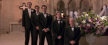 Movie still from “Old School” (2003), directed by Todd Phillips – A group of men in tuxedos posing for a picture; Wide shot, Low angle