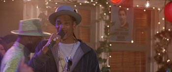 Movie still from “Old School” (2003), directed by Todd Phillips – A man in a hat is singing into a microphone; Close Up shot, Low angle