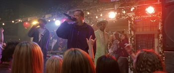Movie still from “Old School” (2003), directed by Todd Phillips – Two men are singing in front of an audience; Medium shot, Over the shoulder angle
