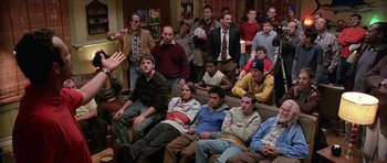 Movie still from “Old School” (2003), directed by Todd Phillips – A group of people sitting in a living room watching tv; Wide shot, High angle