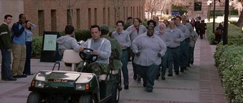 Movie still from “Old School” (2003), directed by Todd Phillips – A group of people walking down a street next to each other; Wide shot, High angle