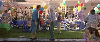 Movie still from “Old School” (2003), directed by Todd Phillips – Two men standing in the grass talking to each other; Wide shot, High angle