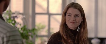 Movie still from “Old School” (2003), directed by Todd Phillips – A person wearing a sweater smiling; Close Up shot, Over the shoulder angle