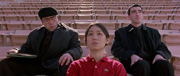 Movie still from “Old School” (2003), directed by Todd Phillips – Three people are sitting in a row of bleachers; Medium shot, Low angle