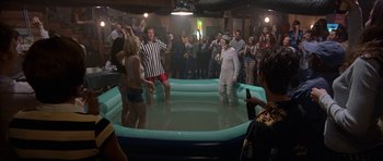 Movie still from “Old School” (2003), directed by Todd Phillips – A group of people standing around a pool of water; Wide shot, High angle