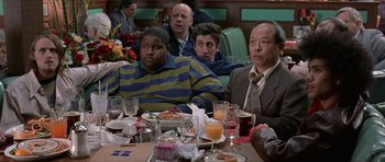 Movie still from “Old School” (2003), directed by Todd Phillips – A group of people sitting at a table with food; Medium shot, Over the shoulder angle