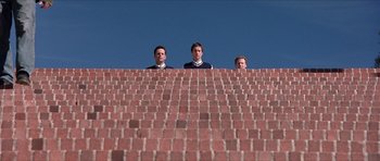 Movie still from “Old School” (2003), directed by Todd Phillips – A group of men standing on top of a brick wall; Extreme Wide shot, Low angle