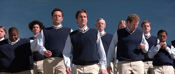 Movie still from “Old School” (2003), directed by Todd Phillips – A group of men standing next to each other wearing sweaters; Medium shot, Low angle