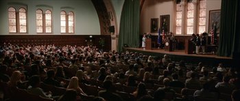 Movie still from “Old School” (2003), directed by Todd Phillips – A large crowd of people sitting in a room; Extreme Wide shot, High angle
