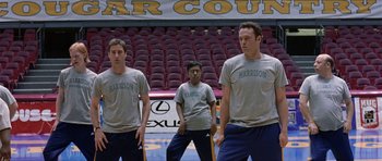 Movie still from “Old School” (2003), directed by Todd Phillips – A group of young men standing in front of an audience; Wide shot, Low angle