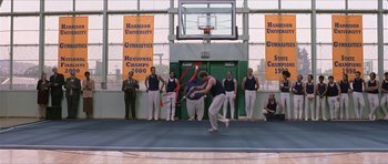 Movie still from “Old School” (2003), directed by Todd Phillips – A man is performing an acrobatic dance on a court; Wide shot, Low angle