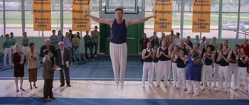Movie still from “Old School” (2003), directed by Todd Phillips – A man standing on one leg in front of a group of people; Wide shot, Low angle