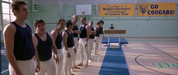 Movie still from “Old School” (2003), directed by Todd Phillips – A group of men standing next to each other in a gym; Wide shot, Low angle