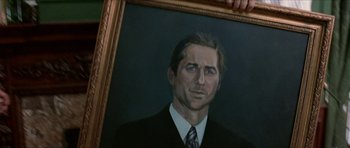 Movie still from “Old School” (2003), directed by Todd Phillips – A painting of a man in a suit and tie; Close Up shot, Low angle