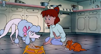 Movie still from “Oliver & Company” (1988), directed by George Scribner – A woman sitting on the floor next to a dog and a cat; Wide shot, High angle