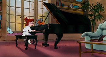 Movie still from “Oliver & Company” (1988), directed by George Scribner – A girl sitting at a piano with a cat on her lap; Wide shot, High angle