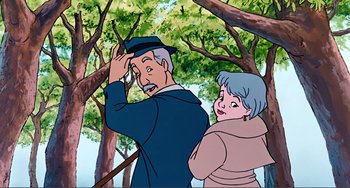 Movie still from “Oliver & Company” (1988), directed by George Scribner – An old man standing next to an older woman in the woods; Medium shot, Low angle