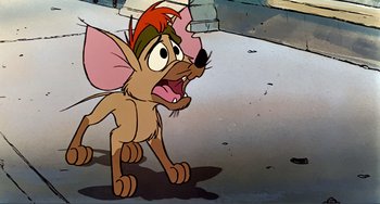 Movie still from “Oliver & Company” (1988), directed by George Scribner – A cartoon of a mouse that is standing in the dirt; Medium shot, High angle