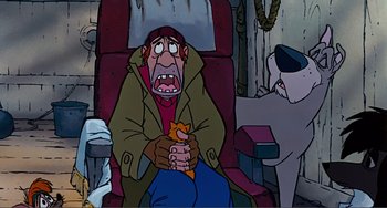 Movie still from “Oliver & Company” (1988), directed by George Scribner – An old man sitting in a chair holding a cat; Medium shot, High angle