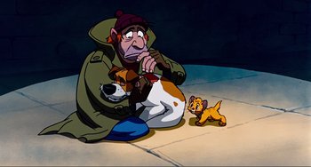 Movie still from “Oliver & Company” (1988), directed by George Scribner – An old man sitting on the ground with a small dog next to him; Wide shot, Low angle