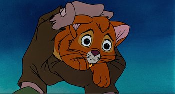 Movie still from “Oliver & Company” (1988), directed by George Scribner – An animated cat is holding a human's arm; Close Up shot, Low angle
