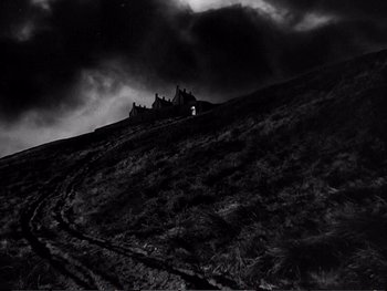 Movie still from “Oliver Twist” (1948), directed by David Lean – A black - and - white photo of a house on a hill; Extreme Wide shot, Low angle