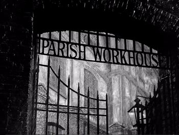 Movie still from “Oliver Twist” (1948), directed by David Lean – A black - and - white photo of a sign for a parish workhouse; Extreme Wide shot, Low angle