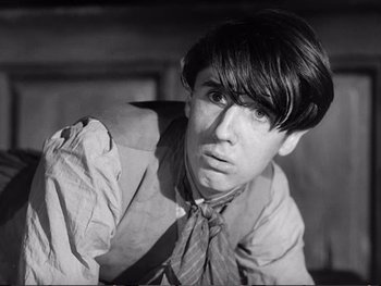 Movie still from “Oliver Twist” (1948), directed by David Lean – A young man in a shirt and tie looking at the camera; Close Up shot, Low angle