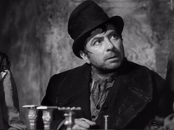 Movie still from “Oliver Twist” (1948), directed by David Lean – A man wearing a top hat looking up at the sky; Close Up shot, Over the shoulder angle