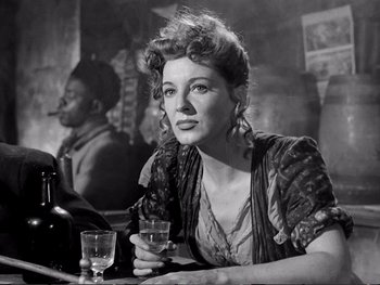 Movie still from “Oliver Twist” (1948), directed by David Lean – A woman sitting at a table with a glass of wine; Close Up shot, Low angle