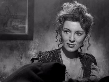 Movie still from “Oliver Twist” (1948), directed by David Lean – A black - and - white photo of a woman in a dress; Close Up shot, Low angle