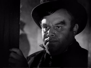 Movie still from “Oliver Twist” (1948), directed by David Lean – A man with a hat and a mustache; Close Up shot, Low angle