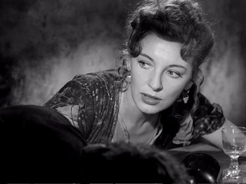 Movie still from “Oliver Twist” (1948), directed by David Lean – An old photo of a woman in a dress looking at the camera; Close Up shot, Over the shoulder angle