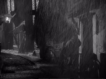 Movie still from “Oliver Twist” (1948), directed by David Lean – A black - and - white photo of a rain storm; Wide shot, Low angle
