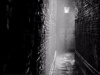 Movie still from “Oliver Twist” (1948), directed by David Lean – A black - and - white photo of a dark alley; Extreme Wide shot, High angle