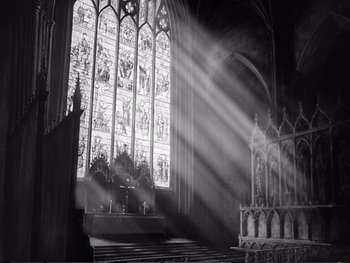 Movie still from “Oliver Twist” (1948), directed by David Lean – The sun is shining through the stained - glass windows; Extreme Wide shot, Low angle