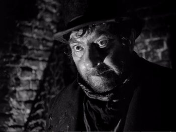 Movie still from “Oliver Twist” (1948), directed by David Lean – A black and white photo of a man in a hat; Close Up shot, Low angle