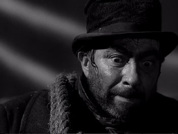 Movie still from “Oliver Twist” (1948), directed by David Lean – A black and white photo of a man wearing a hat; Close Up shot, Low angle