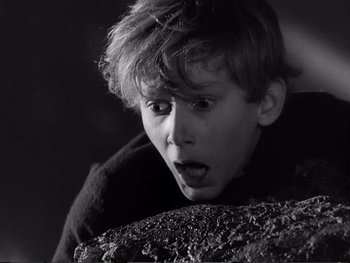 Movie still from “Oliver Twist” (1948), directed by David Lean – A young boy with a surprised look on his face; Close Up shot, High angle