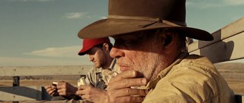 Movie still from “On the Road” (2012), directed by Walter Salles – Two men sitting next to each other on a field; Close Up shot, Low angle