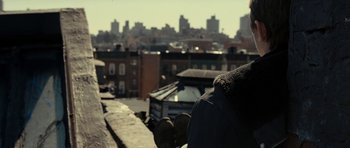Movie still from “On the Road” (2012), directed by Walter Salles – A person standing on a roof top looking out over a city; Close Up shot, Over the shoulder angle