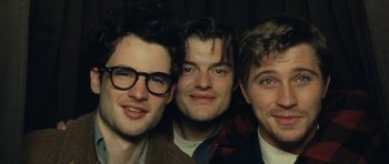 Movie still from “On the Road” (2012), directed by Walter Salles – A group of men standing next to each other in a room; Close Up shot, Low angle