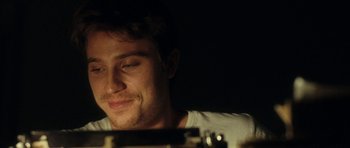 Movie still from “On the Road” (2012), directed by Walter Salles – A person sitting in front of a camera; Close Up shot, Over the shoulder angle