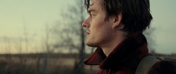 Movie still from “On the Road” (2012), directed by Walter Salles – A person wearing a red jacket; Close Up shot, Low angle