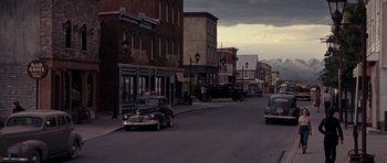 Movie still from “On the Road” (2012), directed by Walter Salles – An old car is driving down the street; Extreme Wide shot, High angle